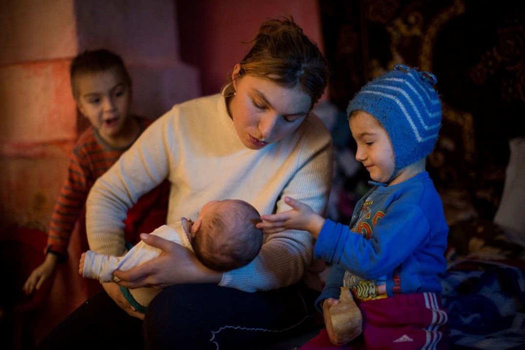 A young mother (age 20) and her three children, Dolj county, Romania.
